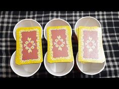 three white dishes with yellow and pink designs on them