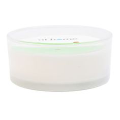 a white container with a green lid on a white background