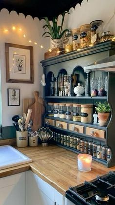 a kitchen filled with lots of pots and pans on top of a wooden counter