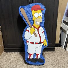 a cardboard cut out of the simpsons character holding a baseball bat and wearing a uniform