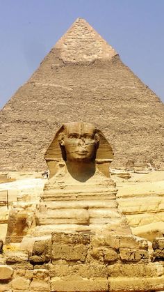 the sphinx and head of an ancient egyptian statue are in front of the great pyramid