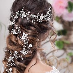 a woman wearing a bridal hair comb with flowers on the back of her head