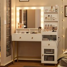 a white vanity with lights on it in a bedroom