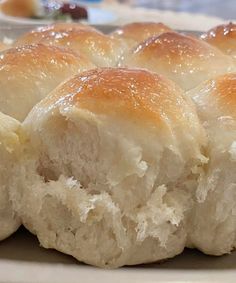 several rolls sitting on top of a white plate