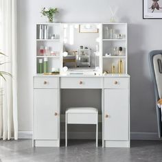 a white desk with a mirror, stool and shelf on it in front of a window