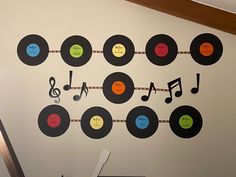 there is a wall decorated with vinyl records and musical notes