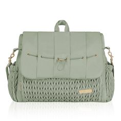 a green handbag with braiding on the front and shoulder straps, sitting on a white surface