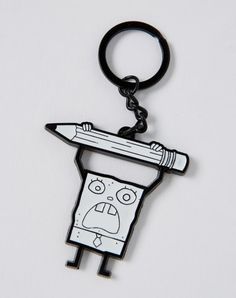 a black and white keychain with a pencil sticking out of it's head