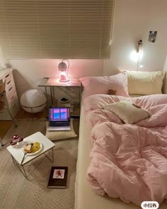 a bed room with a laptop computer on top of it