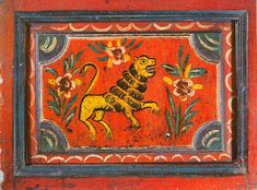 an ornate painting on the side of a red wall with flowers and a lion painted on it