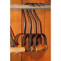 an assortment of kitchen utensils hanging on a rack