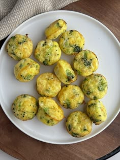 a white plate topped with mini muffins on top of a wooden cutting board