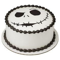 a white cake with black frosting and a jack skellingy face