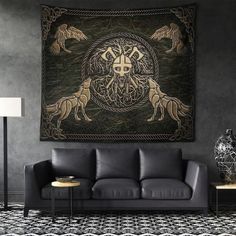 a living room with a couch, table and large tapestry on the wall above it