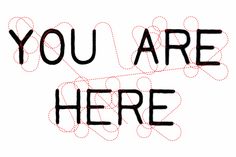 the words you are here written in black ink on a white paper with red lines