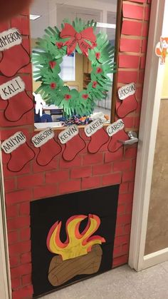 a fire place with a wreath on top of it and paper decorations around the fireplace