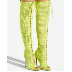 Details A Sexy Over-The-Knee Mesh Boot Featuring A Stiletto Heel, Adjustable Laces, And Back Zipper Closure. Material: Textile/Faux-Suede Calf Circumference: Reg: 16.5"; Wide Calf: 17.5" Color: Neon Yellow Outside Heel Height: 4" Closure: Adjustable Laces Shaft Height: 22" Knee-high Boots For Club In Spring, Trendy Summer Club Boots, Fitted Open Toe Boots For Night Out, Spring Club Knee-high Heels, Knee-high Heels For Club In Spring, Knee-high Heels For Spring Clubbing, Fitted Boots For Summer Night Out, Fitted Boots For Night Out In Summer, Trendy Fitted Heels For Club