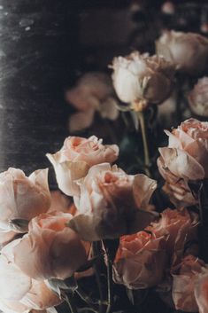 some pink flowers are in a vase on a table