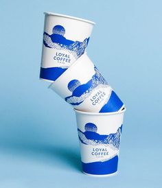 three cups stacked on top of each other in front of a blue and white background