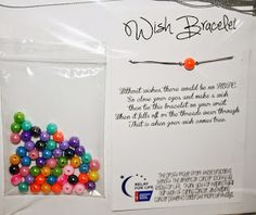 a package with some beads in it on a table next to a sign that says wish bracelet