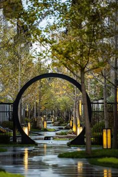 a river running through a lush green park next to tall buildings