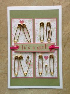 a card with lots of clips attached to it's sides and the words it's a girl