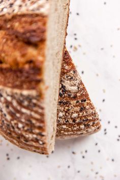 a piece of bread that is cut in half on a white surface with sprinkles