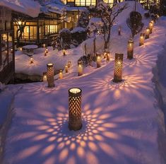 many candles are lit up in the snow