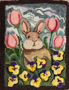 a rug with a rabbit and flowers on it