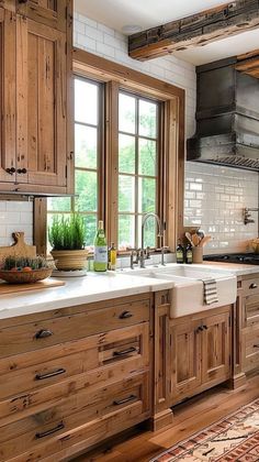 a large kitchen with wooden cabinets and white counter tops, an area rug on the floor