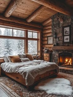 a bedroom with a bed, fireplace and large windows in the cabin style home that has wood paneling on the walls