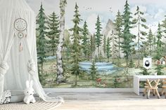 a child's room with a forest mural on the wall