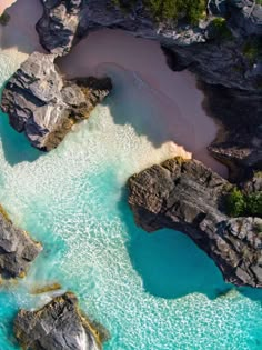 an aerial view of the water and rocks