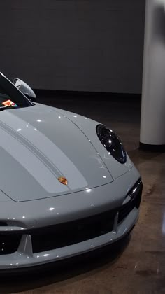 a silver sports car parked in a garage