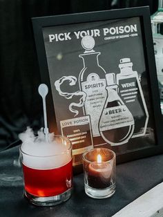 a table topped with two glasses filled with liquid next to a sign that says pick your poison