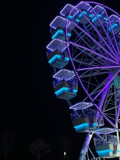 a large ferris wheel lit up at night