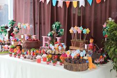 a table topped with lots of cakes and desserts