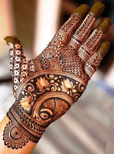 a woman's hand is decorated with hennap and intricate designs on it