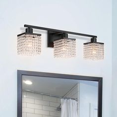 a bathroom with a mirror and lights above it