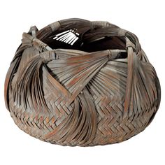 a woven basket with tassels on it