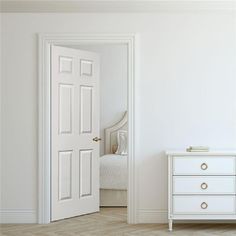 an open door leading to a bedroom with a white bed and dresser in the corner