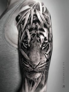 a man with a tiger tattoo on his arm