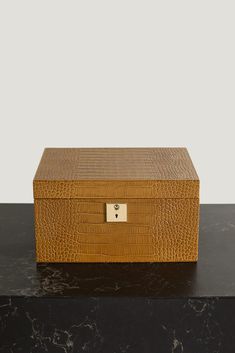 Heritage brand Smythson can be trusted to keep your most precious jewelry safe. This 'Mara' box is handcrafted from croc-effect leather in a soft taupe hue. It opens to reveal multiple compartments and a nubuck lining to protect your collection from scratches. Use the removable tray to pack trinkets when you travel. Leather Jewellery, Leather Jewelry Box, Jewelry Safe, Fine Watches, Jewel Box, Heritage Brands, Precious Jewelry, Leather Jewelry, Luxury Design