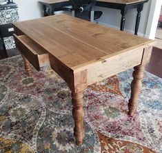 a wooden table sitting on top of a rug