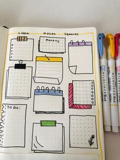 an open planner book with markers on it