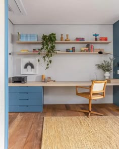 a room with a desk, shelves and a chair in the corner next to it