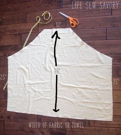 an apron is shown with scissors and sewing thread on the table next to it, which shows how much fabric should be sewn