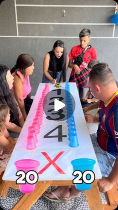 a group of people sitting around a table with numbers on it