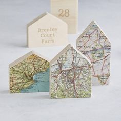 three small wooden houses are shown with a map on the front and back, along with a block that says brenley court farm