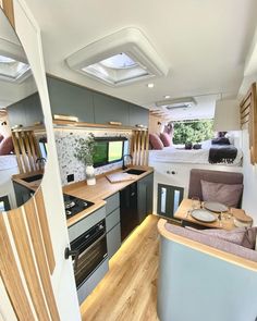 the interior of an rv with wood flooring and white walls is shown in this image